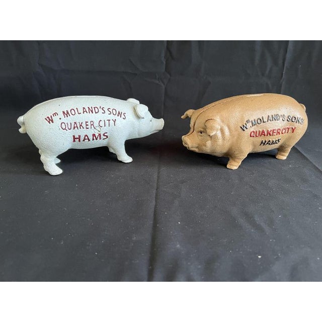 Pair of cast iron Wm Moland & Sons Quaker City pig money boxes