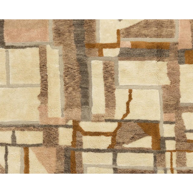 Artistic hand-knotted wool rug with a complex grid of squares and rectangles in a warm palette of Taupe, Desert Rose,...