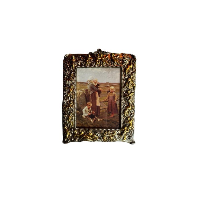 An exceptional large vintage picture frame, masterfully crafted in Italy and adorned with intricately sculpted cherubs in...