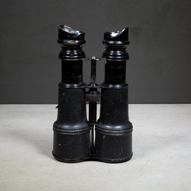 A 19th century pair of leather wrapped military binoculars by Sportier Paris with "Sportier Paris" and "Day Night"...