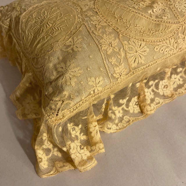 Antique hand made French lace, likely Normandy. Lace designs in floral pattern with a scalloped border. Cover over a...