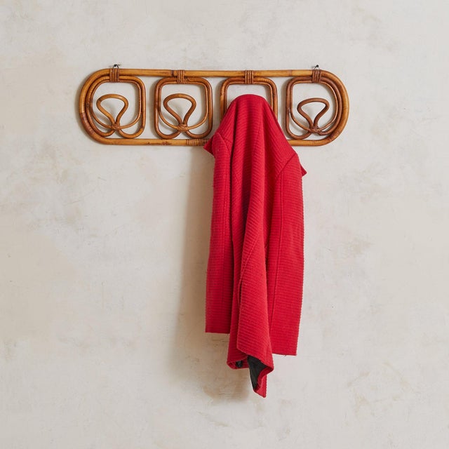 A 1960s Italian wall-mounted coat rack attributed to Franca Helg and Franco Albini for Vittorio Bonacina. Crafted from...