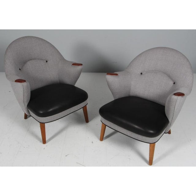 Kurt Olsen lounge chairs with legs of oak and nails of teak. New upholstered with grey rewool from Kvadrat, seat and...