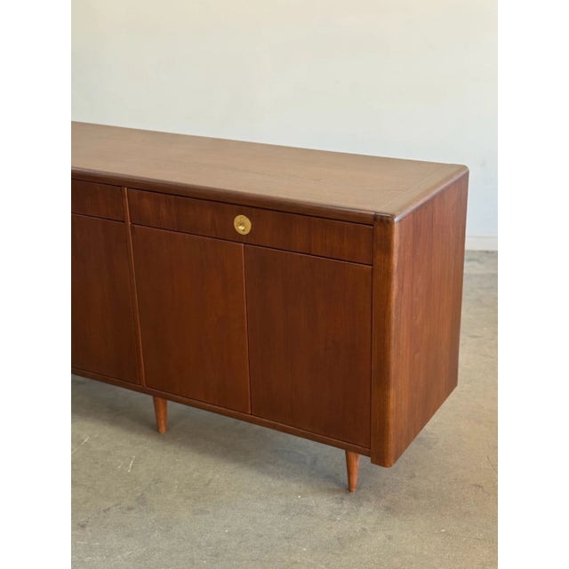 W63 D20 H33.5 Fully restored teak credenza with a great minimal design. Item features inset solid brass hardware, push...