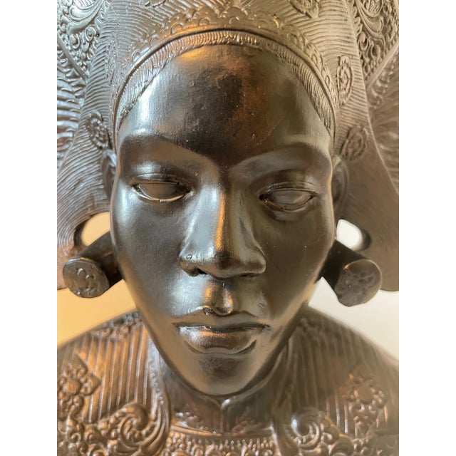 An exceptional mid-century patinated bronze or heavy cast metal sculptural bust depicting a traditional Balinese Janger...