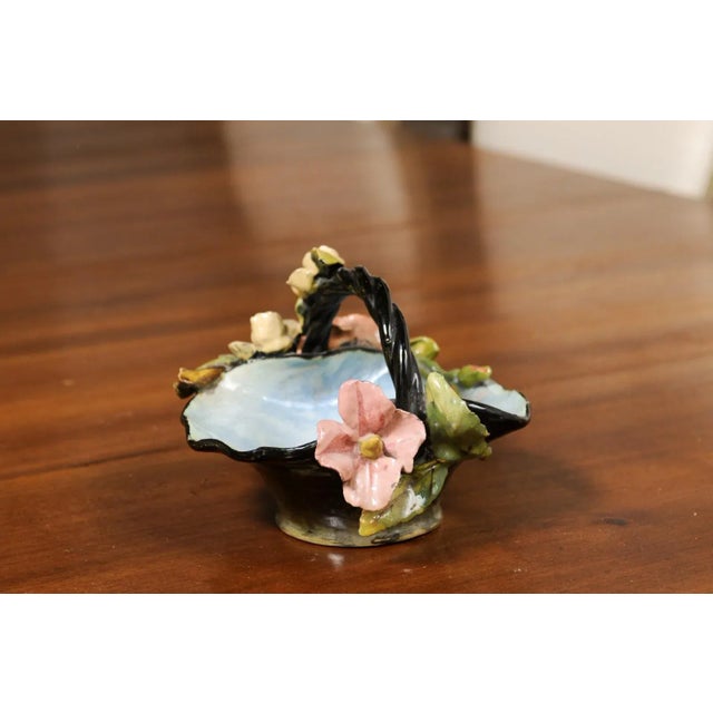 A French majolica basket from the late 19th century with high relief floral barbotine décor. Created in France during the...