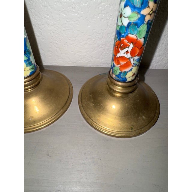 A striking pair of vintage late-20th-century Chinese brass and cloisonné enamel candlestick holders. This matching set...