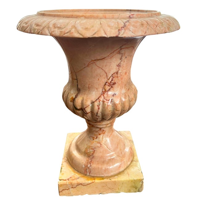 A beautifully sculptural vintage carved marble urn in warm blush-pink tones with dramatic rust, coral, and soft gray...
