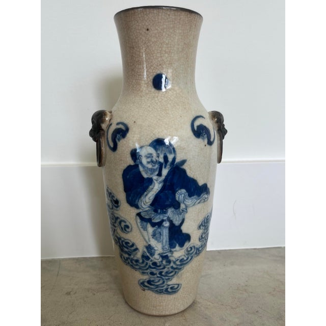 An absolutely gorgeous, hand-painted, blue and white Nanking crackle glaze vase with paired bronzed fu dog handles to ward...