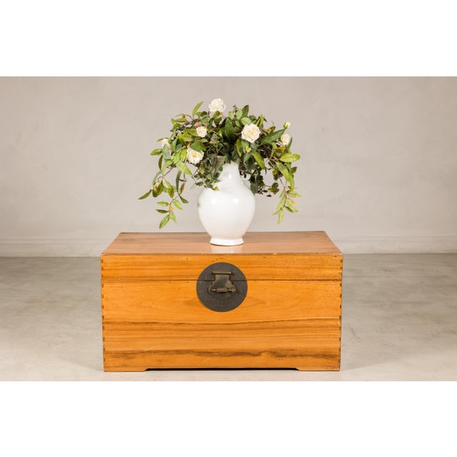 This vintage Chinese pine trunk combines clean lines, warm honey-toned wood, and understated brass hardware in a form that...
