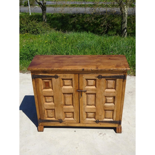 Very antique Tuscan sideboard assembled with wooden dowels, with solid wood paneled doors and sides, demonstrating...