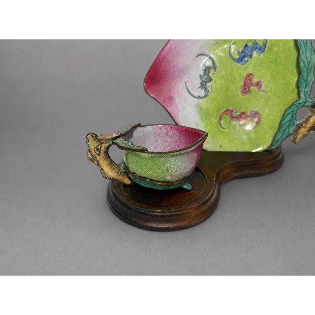 A fine pair of Chinese Canton painted enamel peach-form cups and saucers, Qing dynasty, likely 19th century, each worked...