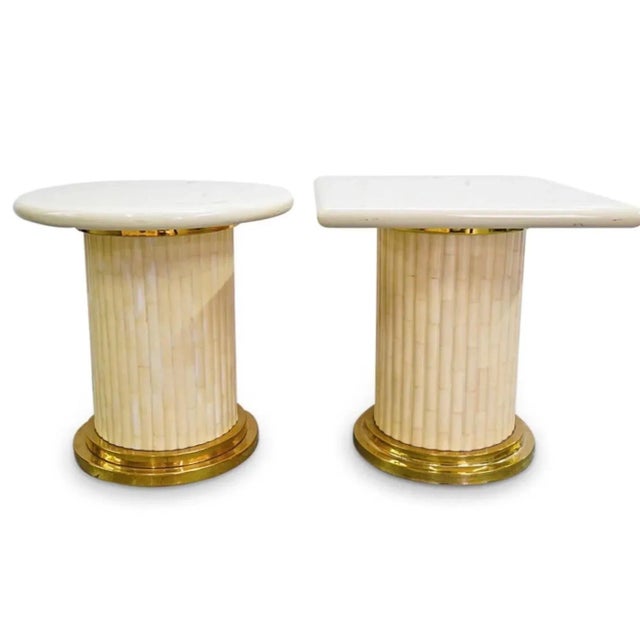 Two side table by Enrique Garcia-one crowned with a square top, one with a round top-each composed of ivory toned acrylic...
