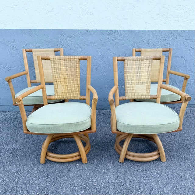 A stylish blend of coastal elegance and boho sophistication, this set of four vintage swivel dining armchairs showcases a...