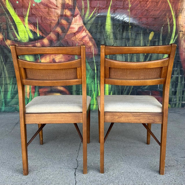 Pair of came back walnut dining chairs by American of Martinsville. These chairs sit comfortably with the right curves and...