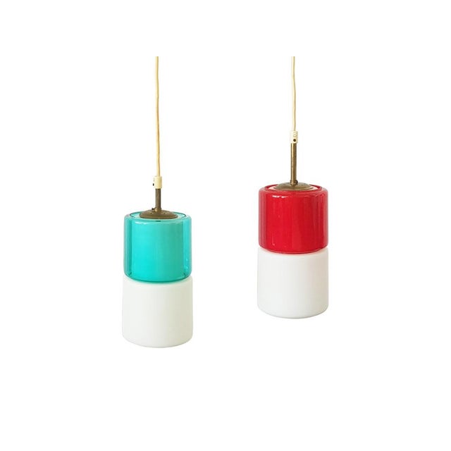 Pair of 2 small pendant lamp in black aluminum, brass and colored glass shades. Very good vintage condition; normal brass...