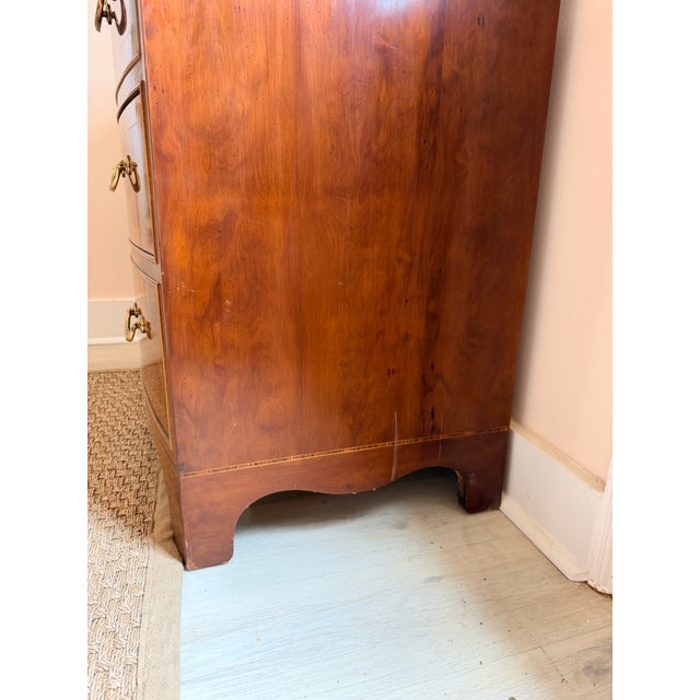 A vintage Henredon bow front chest of drawers, crafted in the United States during the mid-20th century. Known for...