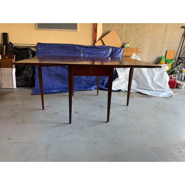 Vintage federal style solid wood drop leaf dining table The table features a drop leaf and gate leg design. Good condition...