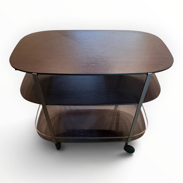 Battista Bar cart from Italian furniture house Zanotta. Designed in 2009 by Ana Deplano, the cart has three oval tiered...