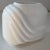 Postmodern Art Deco Revival style, characterized by the geometric swish or wave. Glossy white glazed ceramic.