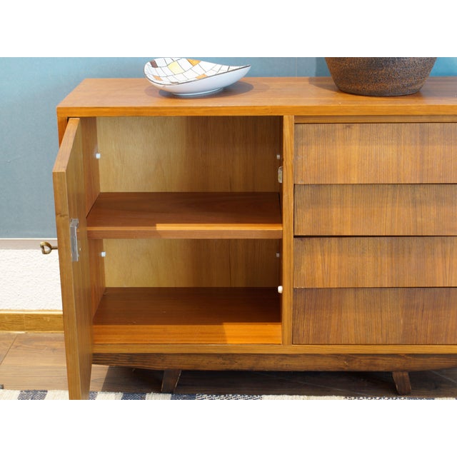 Stylish small chest of drawers from the 1960s. Walnut veneer. Very high-quality workmanship and unusually heavy for its...