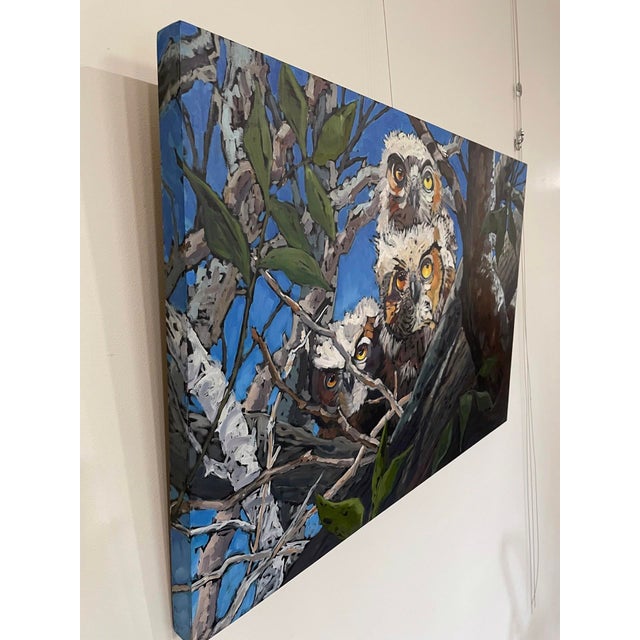 This oil painting depicts a trio of owls nestled in the branches of a tree, their expressive eyes drawing the viewer in...