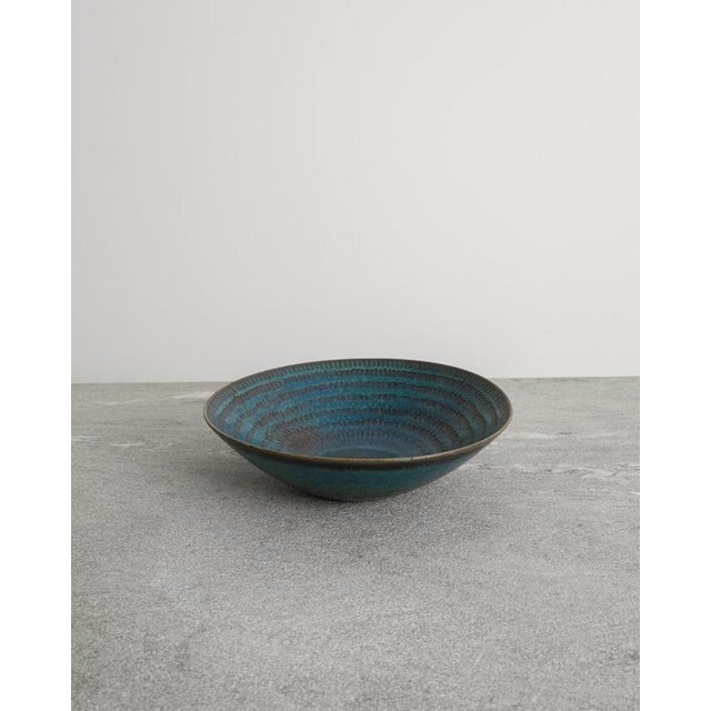 Rare Swedish mid century decorative ceramic bowl in a blue glaze with brown impressed details designed by Stig Lindberg...