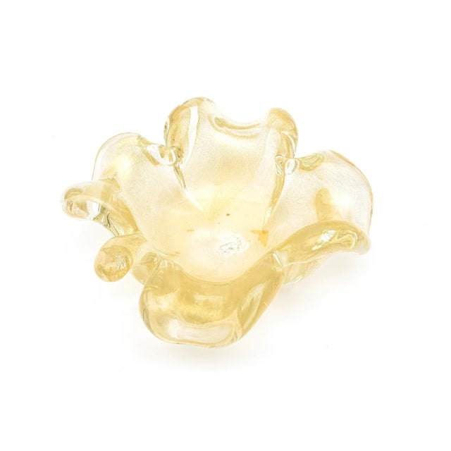 This vintage mid century modern Murano glass bowl is in the shape of an opened flower with a stem at the end. It is filled...