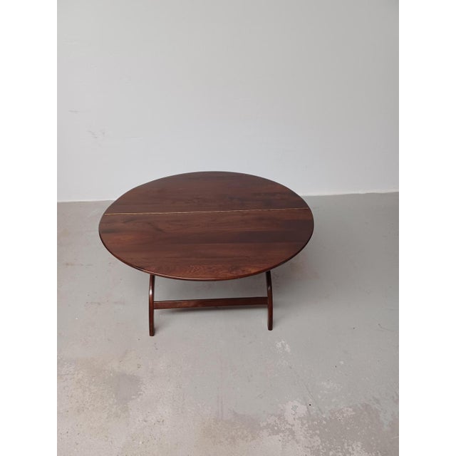Danish circular Handcrafted foldable mahogany coffee table, 1960s. The rare well designed and very well crafted foldable...