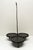 A primitive early American cast iron fireplace hearth triple griddle with handle. The griddle is resting on three feet...