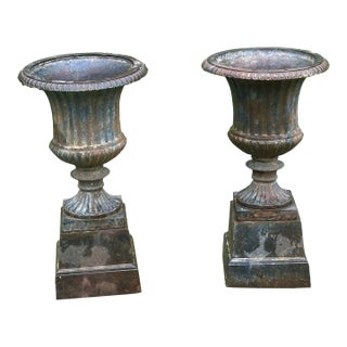 Late 20th Century Neoclassical Cast Iron Urns on Plinths - A Pair For Sale