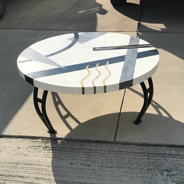 Tessellated marble in geometric shape with brass inlay with metal legs. Boast a Memphis-inspired whimsy touch to any room....