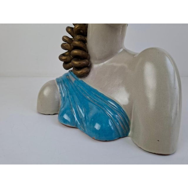 A refined art deco ceramic bust of a woman, produced in czechoslovakia circa the 1930s. The sculpture features an...