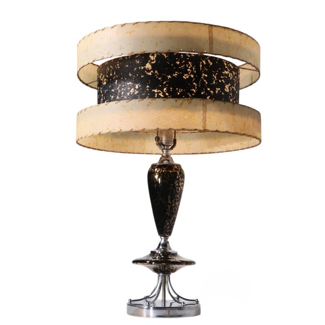 Incredible mid century ceramic, chrome and fiberglass table lamp, made in USA circa 1950's. The lamp features a chrome...