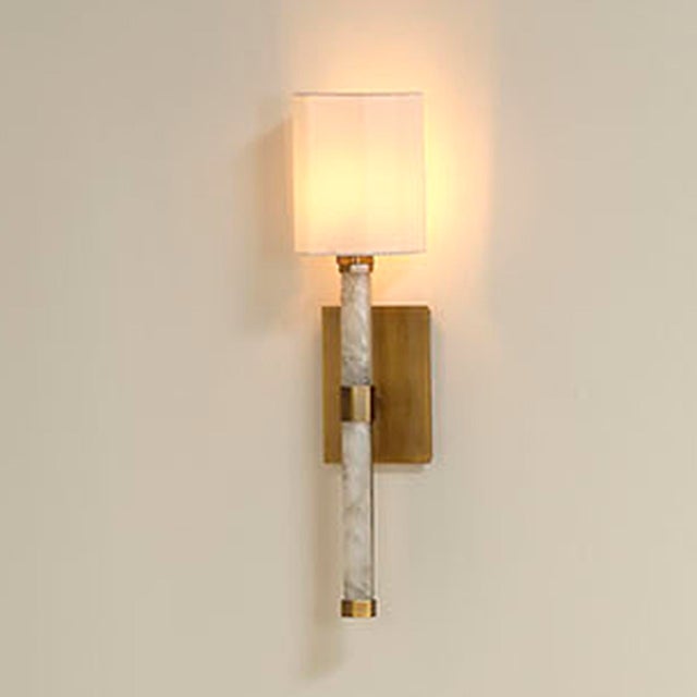 Timeless materials, contemporary lines, and a warm modern metallic finish are expertly combined in this striking sconce....