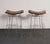 Set of four modern bar stools by Fernando Jaeger (ca. 1990s, Brazil). Composed of stainless steel frames with square foot...