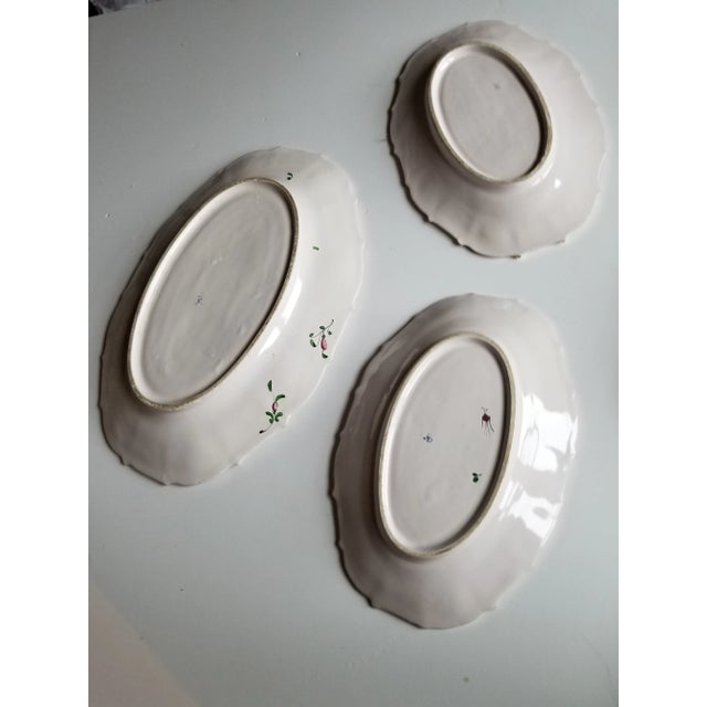 Set of three vintage French Luneville oblong serving plates with floral decorations. Great on a wall for decorating or on...