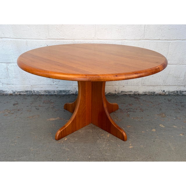 Beautiful mid-century modern round coffee table crafted in warm, richly grained teak. This striking piece features a...