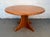 Beautiful mid-century modern round coffee table crafted in warm, richly grained teak. This striking piece features a...