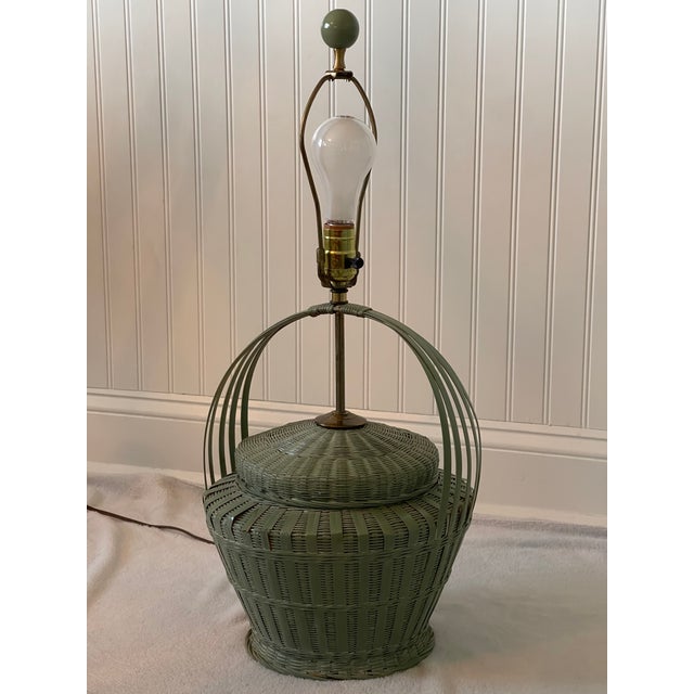 Vintage painted green wicker basket style table lamp. This super cute basket lamp measures 11” at its widest section and...