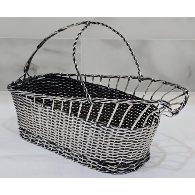Elevate your entertaining with this handsome handmade silverplate wire wine basket, a beautifully crafted piece of...