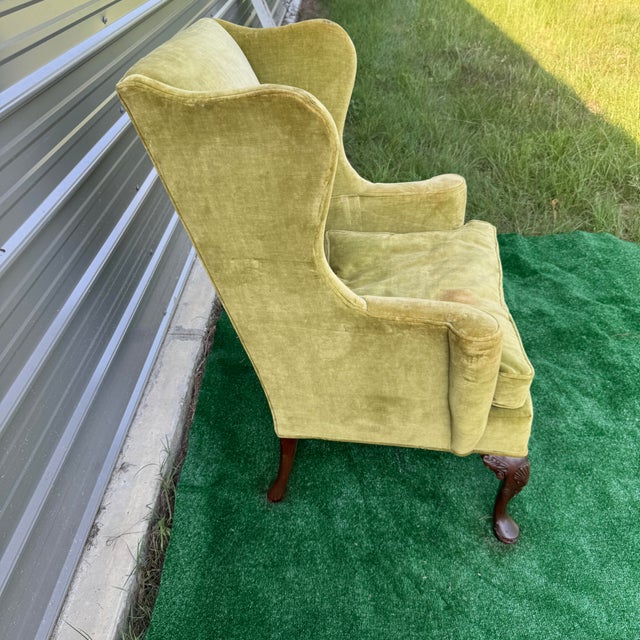 Late 20th century Hickory Chair Company wingback chair. Traditional style. Clean cut lines for a wingback. Shell motif on...