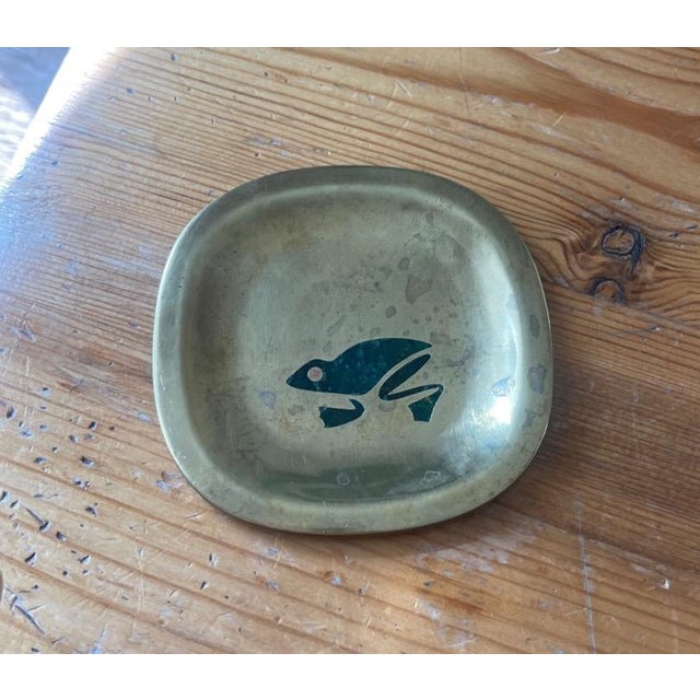 Brass dish with jade frog motif.