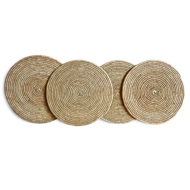 Vintage hand woven natural Kuba grass round placemat. May also be used as beautiful wall art. Wonderful in groupings. Each...