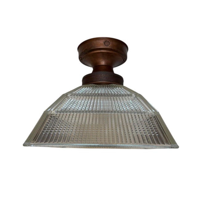 The industrial style of this light fixture would pair well with any modern type of architecture. The Halophane prismatic...