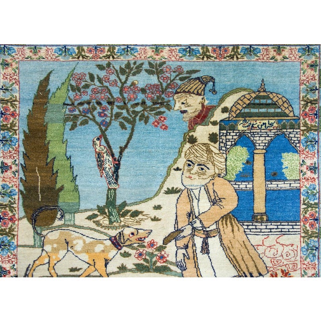 This exquisite early 20th-century Persian hand-knotted pictorial Isfahan rug captures the legendary poet Hatim al-Tai in a...