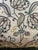 This is a set of two square decorative pillows with a blue floral design on a canvas background. The floral design is...