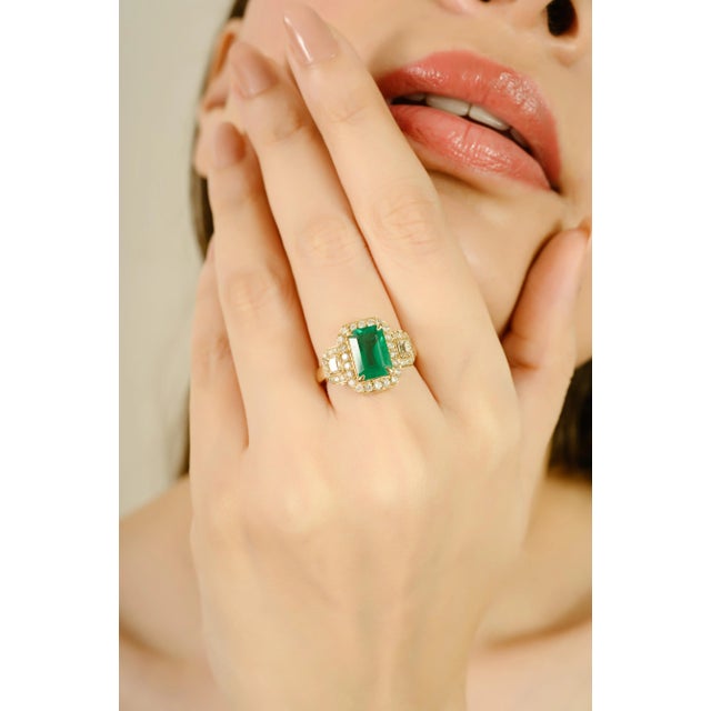 This luxurious emerald cocktail ring features an emerald-cut natural emerald weighing 2.78 carats, beautifully accented by...