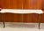 A large and genuinely dramatic console table with a scrolling gilt-iron base carrying a shaped white marble top with soft...