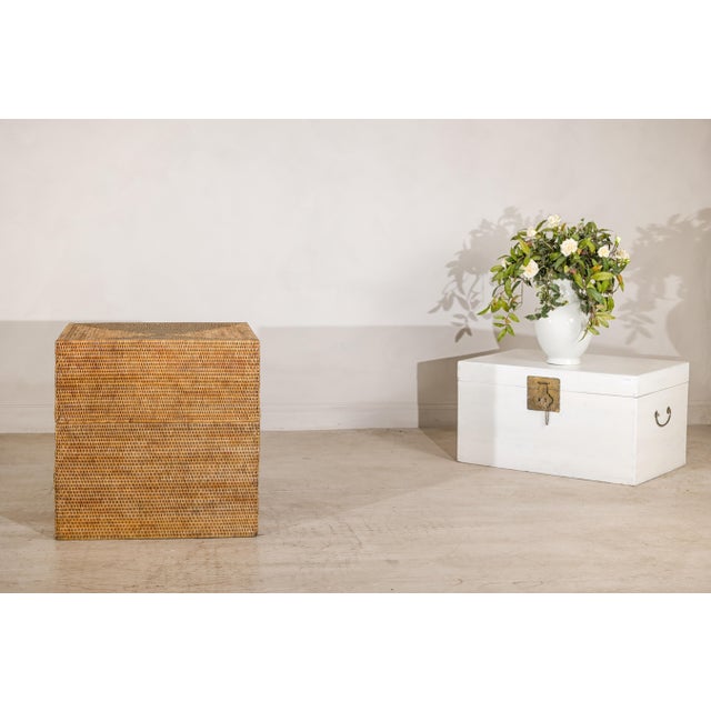 This large square vintage storage box is fully clad in tightly woven natural rattan, forming a clean, architectural cube....